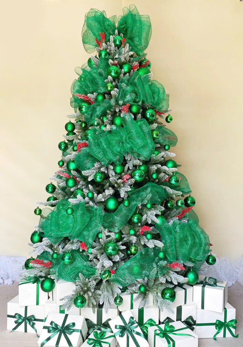 Green Christmas tree decoration detail with coordinated ornaments